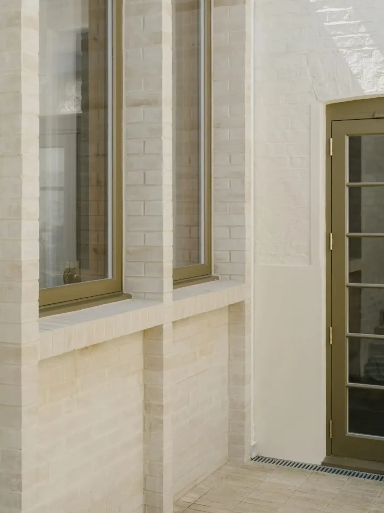 Exposed structural timber frame inside residential extension with high ceilings and enlarged openings