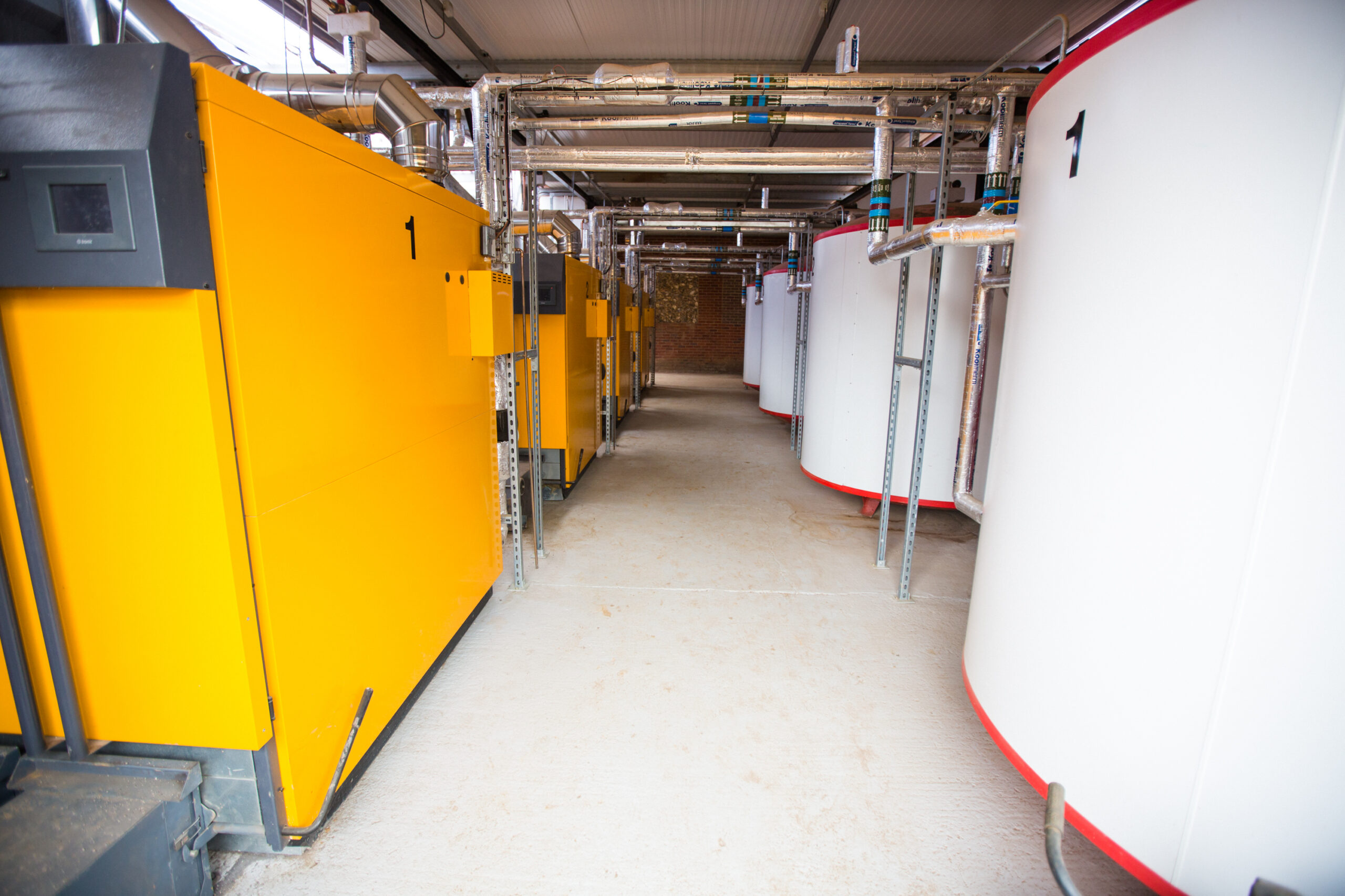 Biomass boiler and thermal buffer tanks storing surplus solar energy at H.G. Matthews' Brickworks